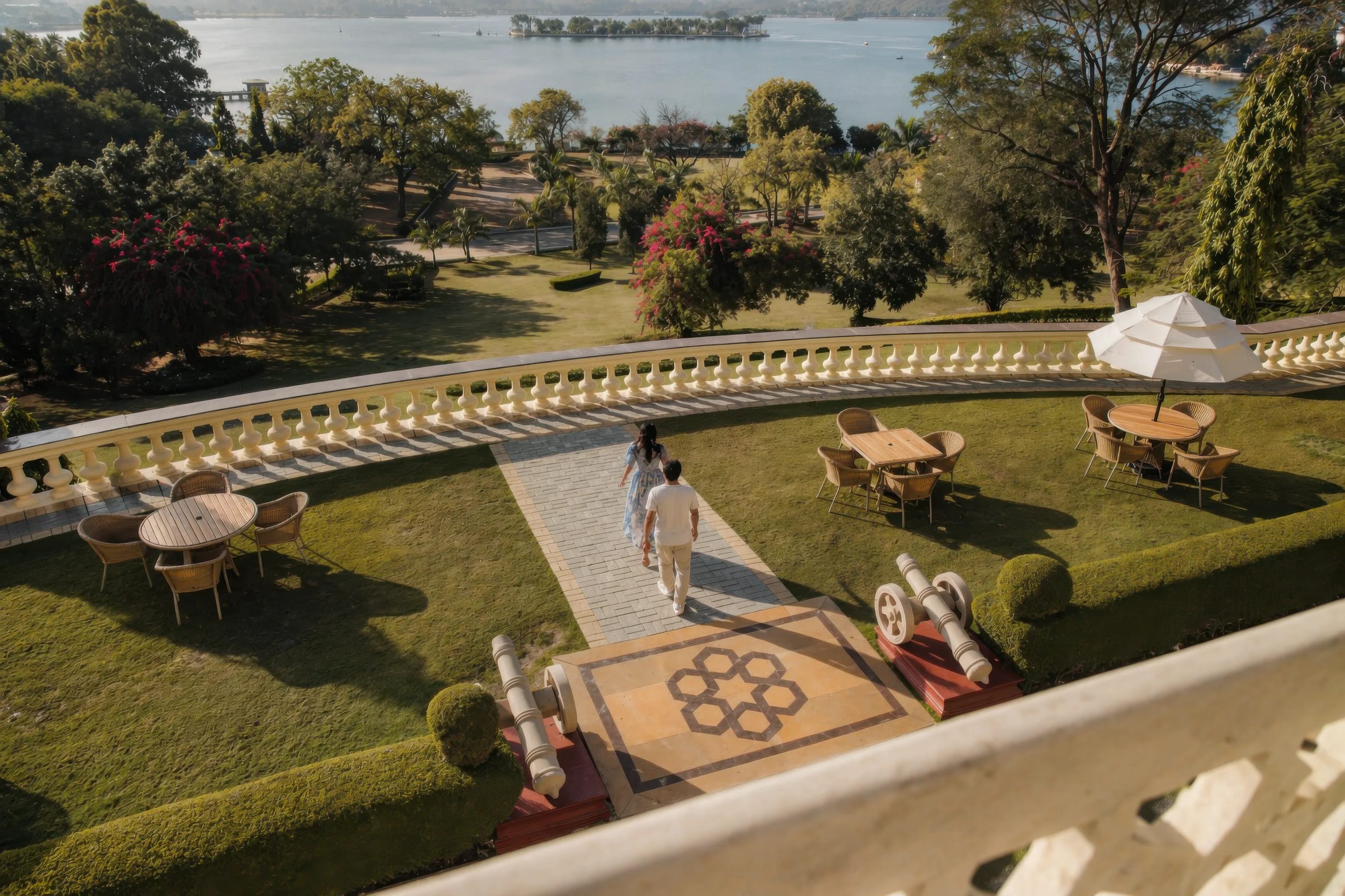 A couple walking through a garden courtyard beside a lake