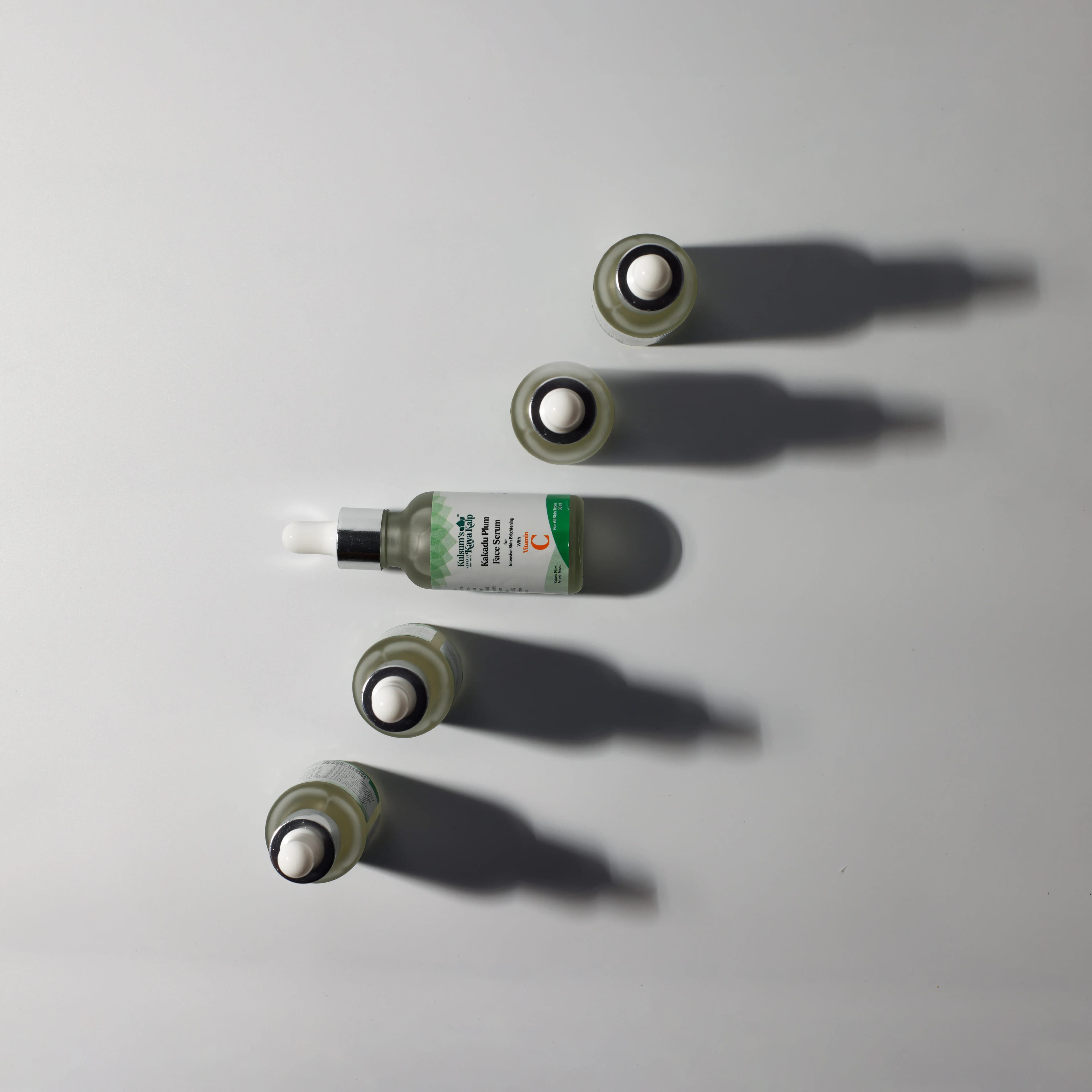 Glass dropper serum bottles arranged in a studio