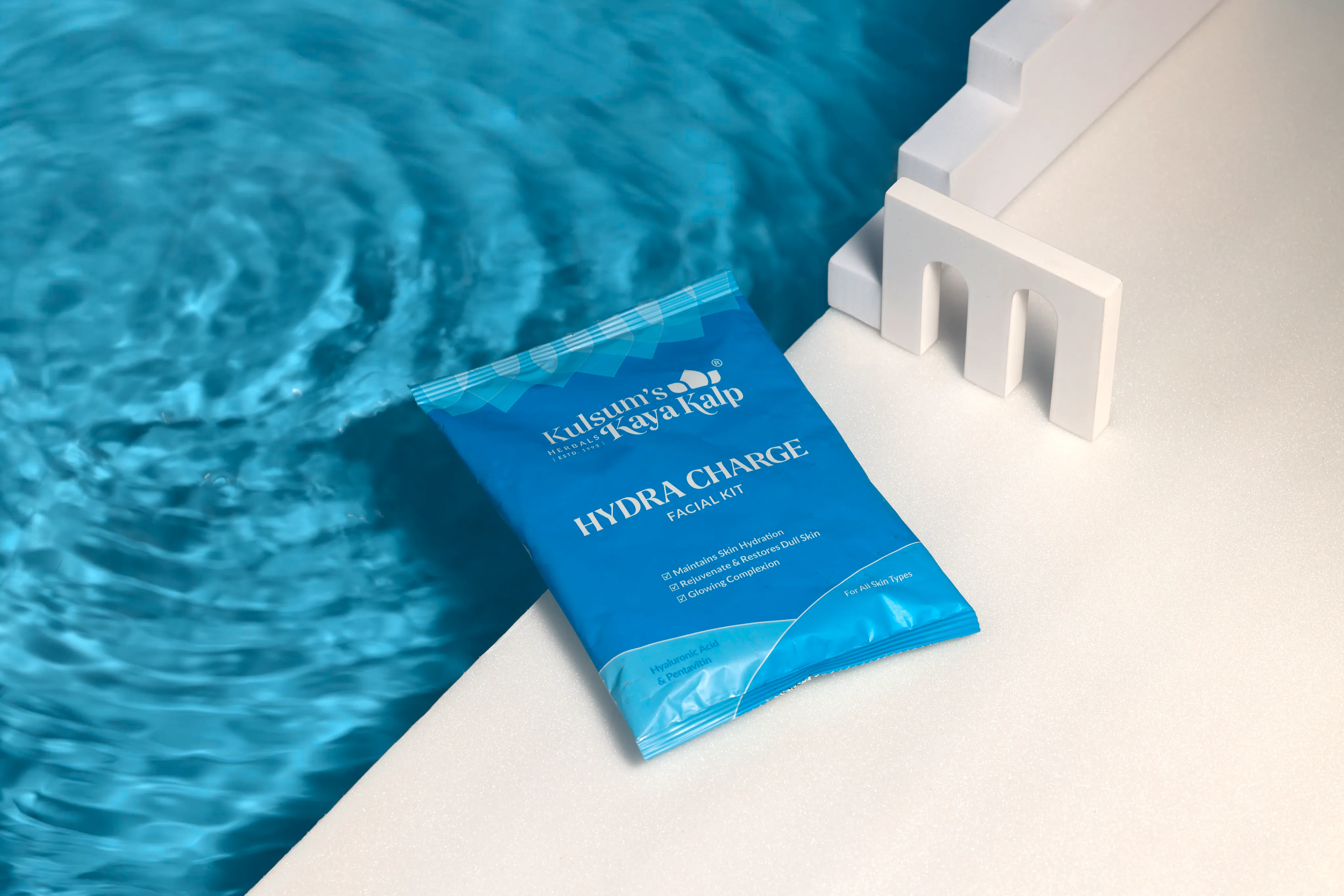 Hydra Charge skincare beside a swimming pool