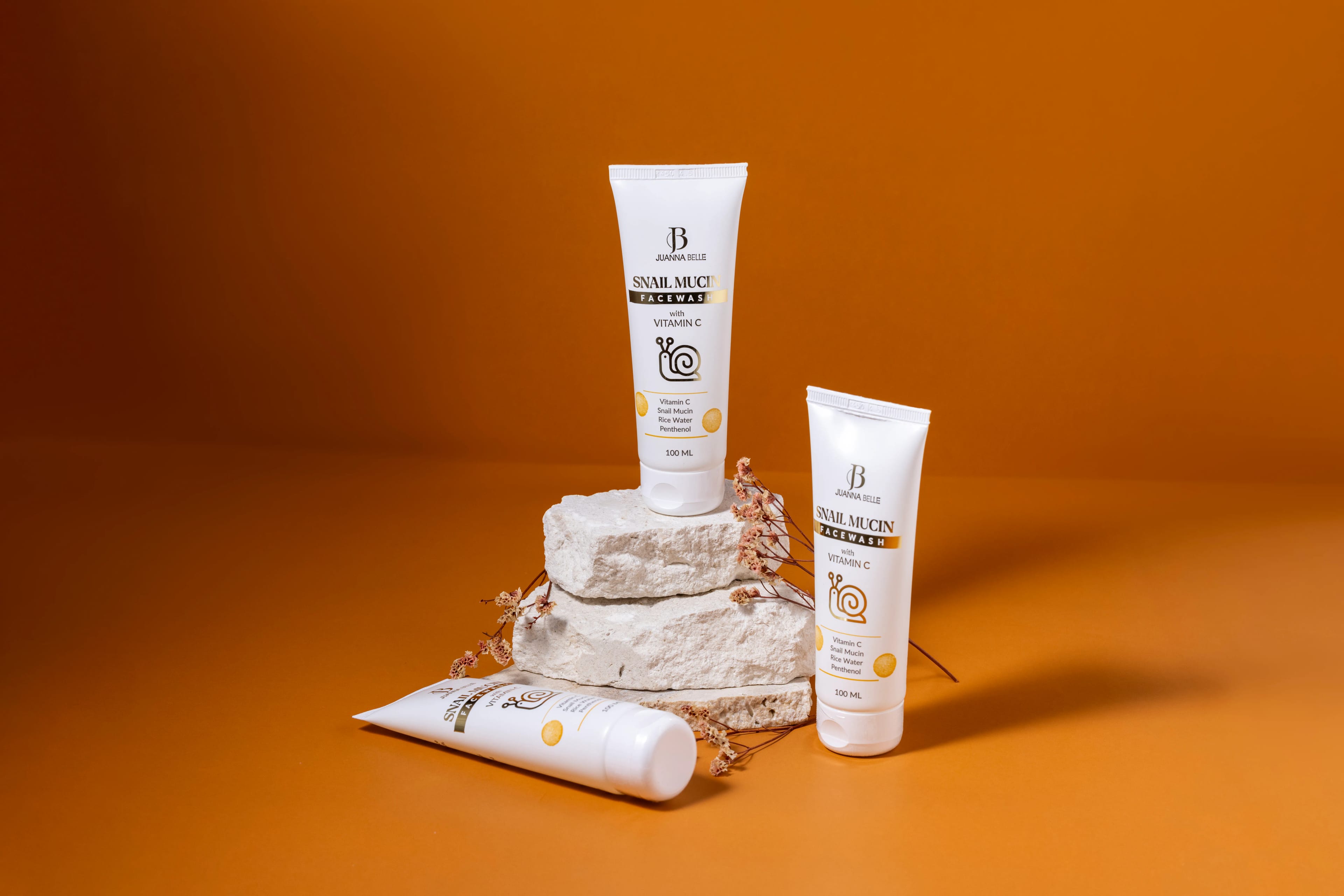 Skincare products arranged on a warm studio set